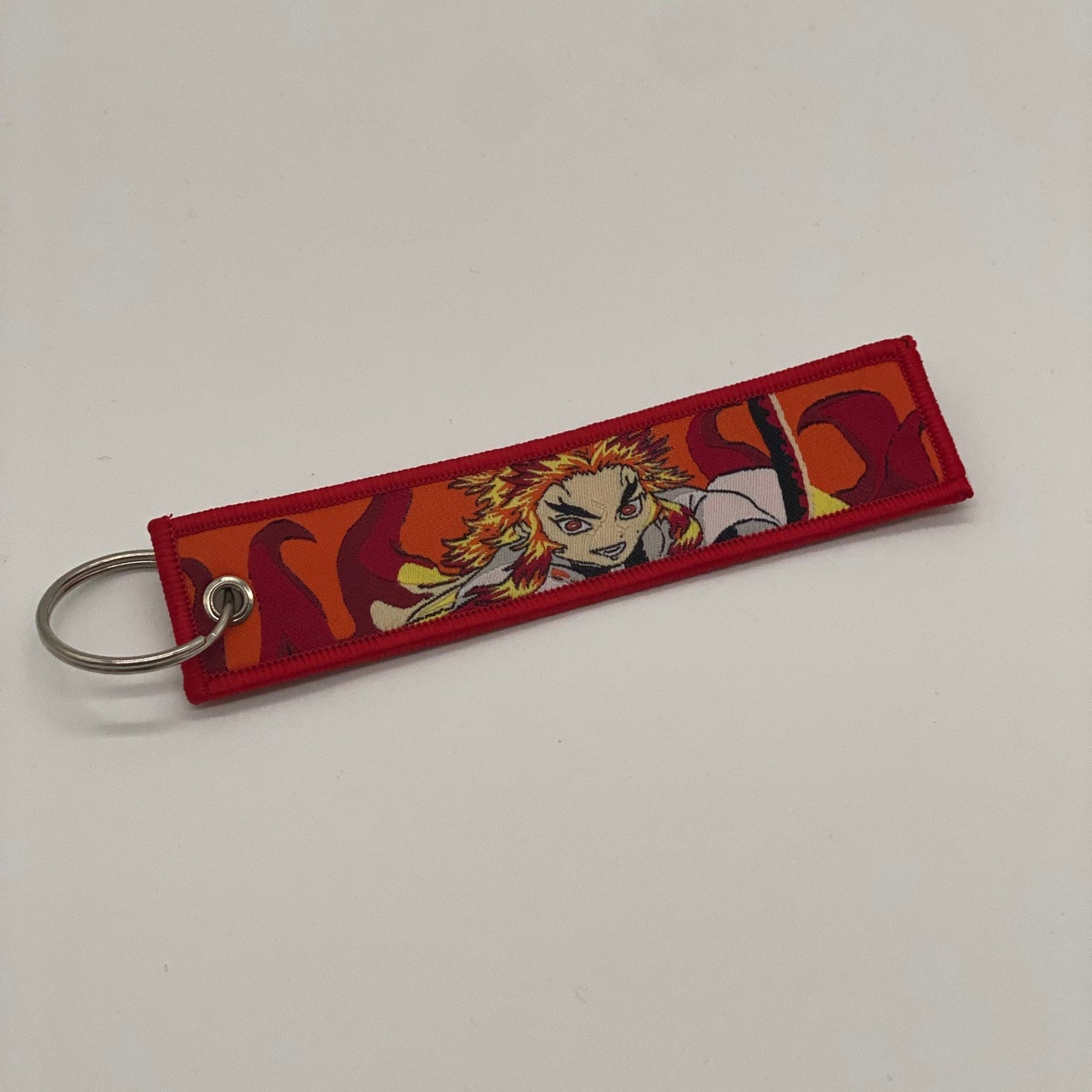 LIMITED DEMON SLAYER KYOJURO RENGOKU DUAL-SIDED EMBROIDERED KEY CHAIN