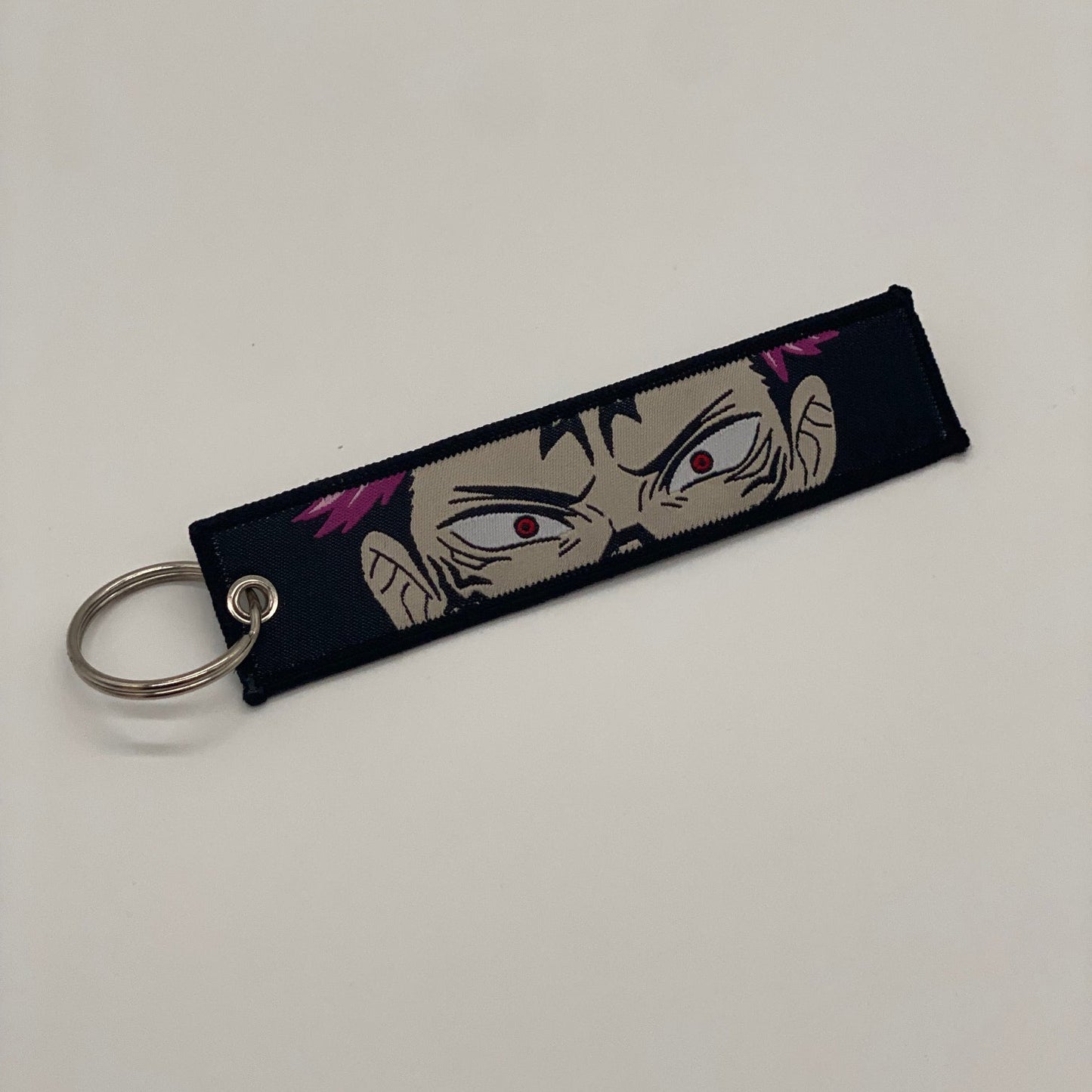 LIMITED JUJUTSU KAISEN YUJI ITADORI SUKUNA DUAL-SIDED EMBROIDERED KEY CHAIN/TAG